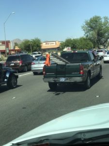 Ladder with Orange Shirt tied to the ladders rungs trying to DOT compliant but doesn't have the professional look of out Ladder Flag